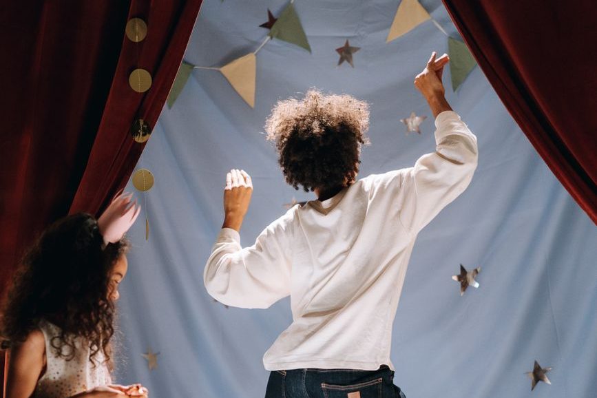 backview of mother dancing in their home made theatre